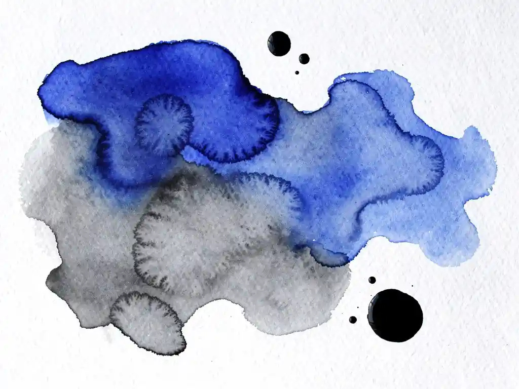 Abstracte aquarelverf in diepblauw en houtskoolgrijs vloeit over getextureerd wit papier met natuurlijke kleurovergangen